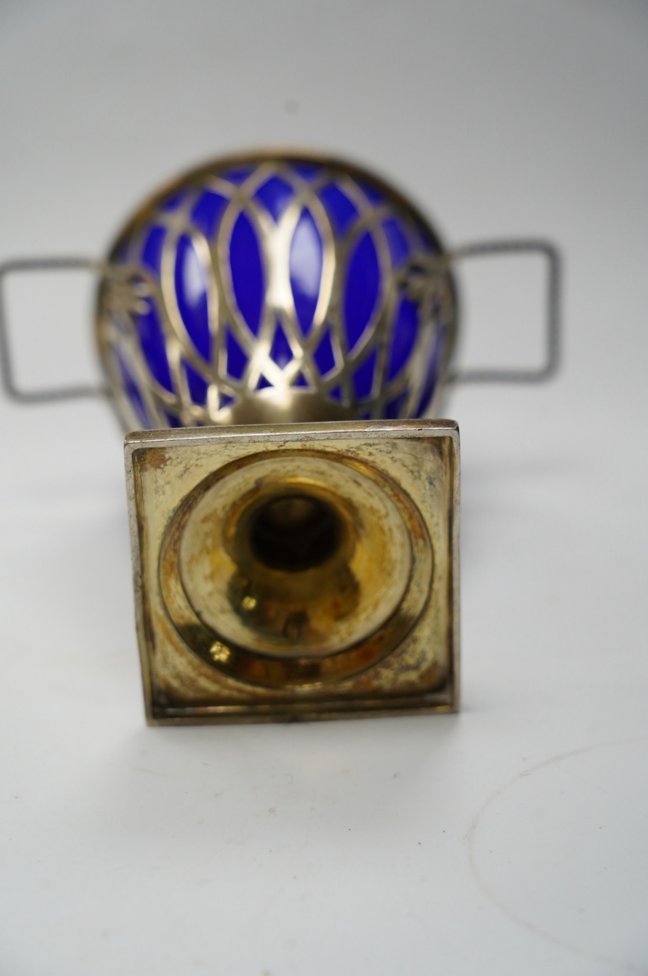 An Edwardian repousse silver porringer, Daniel & John Welby, London, 1905, height 73mm, together with a late Victorian silver two handled sugar vase with blue glass liner, London, 1895. Condition - fair